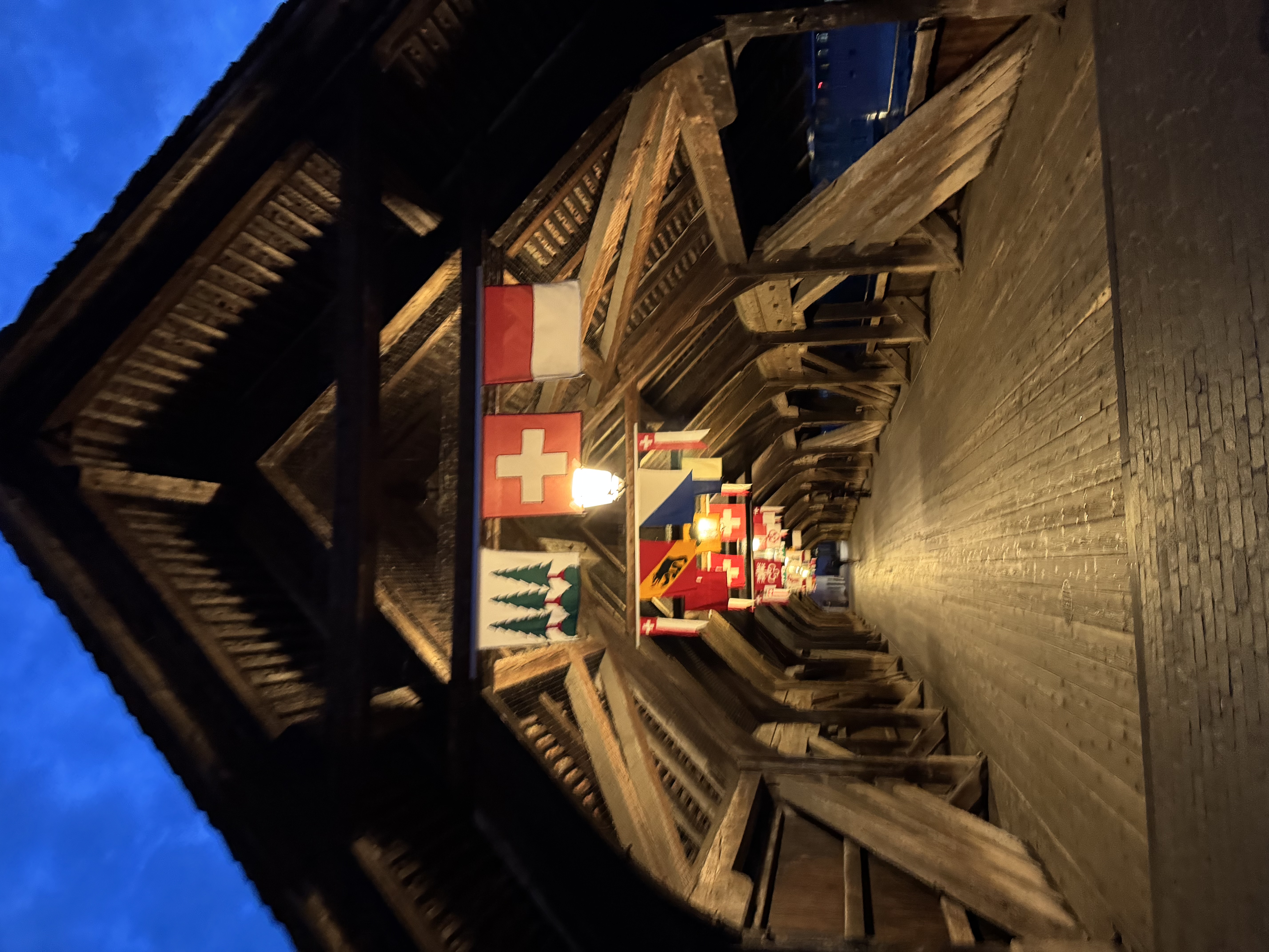 The old covered wooden bridge lit up at dusk
