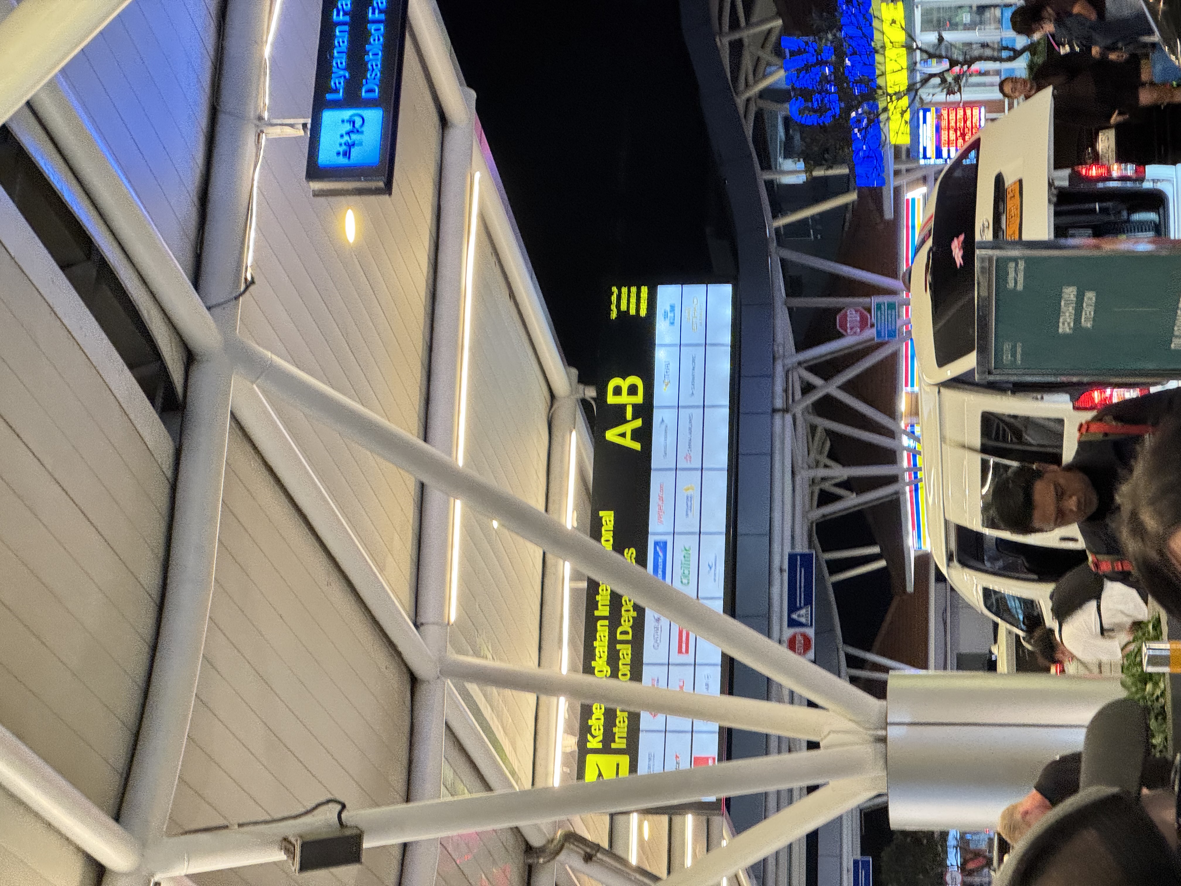 Under the canopies at Denpasar, International Departures, gates A-B.