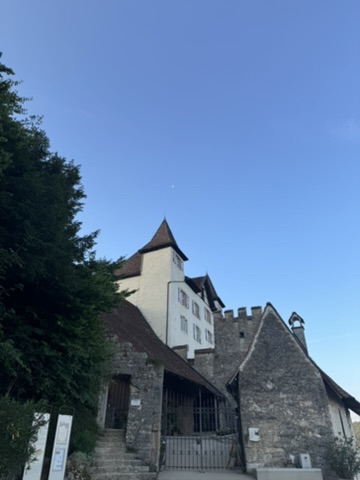 The white tower of Schloss Wartenfels against the evening sky.
