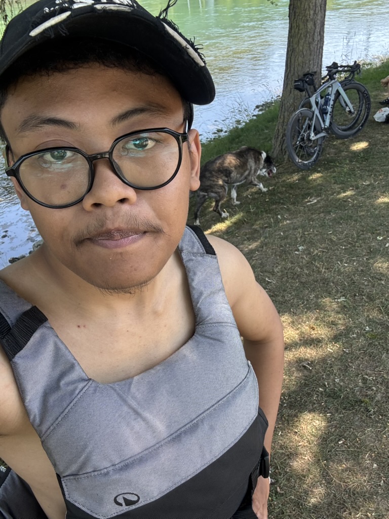 Me in my life vest, ready to go, with a curious dog behind