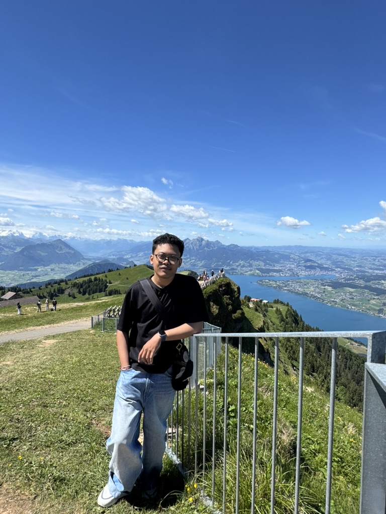 Me at the viewpoint, with the lake and Alps behind.